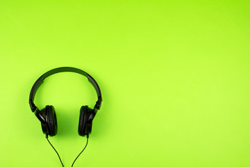 black headphones on a green background