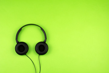 black headphones on a green background