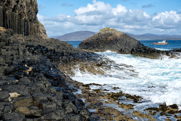 The tide coming in and crashing on the unique basalt columns of the Isle of Staffa. Staffa is a...
