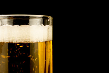 glass of beer foam bubbles close up, copy space, selective focus , black  background