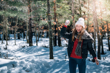 Fototapeta premium portrait Young pretty woman enjoying and playing with snow in winter