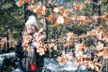 portrait Young pretty woman enjoying and playing with snow in winter