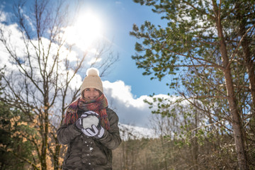 portrait Young pretty woman enjoying and playing with snow in winter