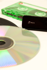 concept photo of evolution of record methods from vinyl to cassette compact disk and digital music...