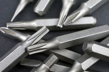 Fototapeta premium Set of heads for screwdriver (bits) Tools collection copy space, close up, selective focus. dark background