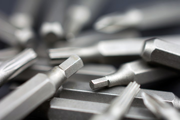 Set of heads for screwdriver (bits) Tools collection copy space, close up, selective focus. dark background