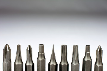 Set of heads for screwdriver (bits) Tools collection copy space, close up, selective focus blurred neutral background