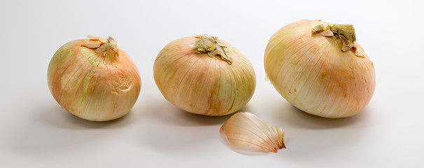 Three onions in a light small to large