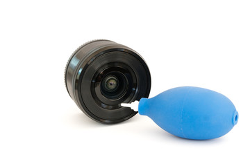 Lens and dust blower isolated on white background. Photography equipment cleaning concept.