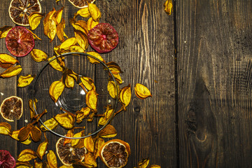 Cotton petals with dried lemons on a wooden background with checkered textiles. Place for text. Decorative background.