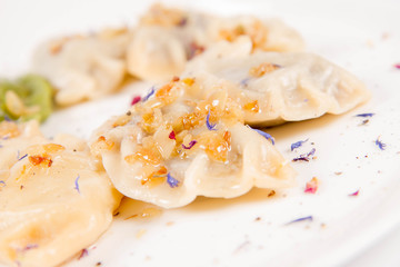 Dumplings with different kinds of stuffing decorated on a plate