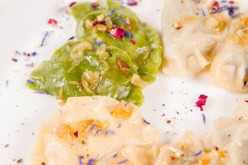 Dumplings with different kinds of stuffing decorated on a plate