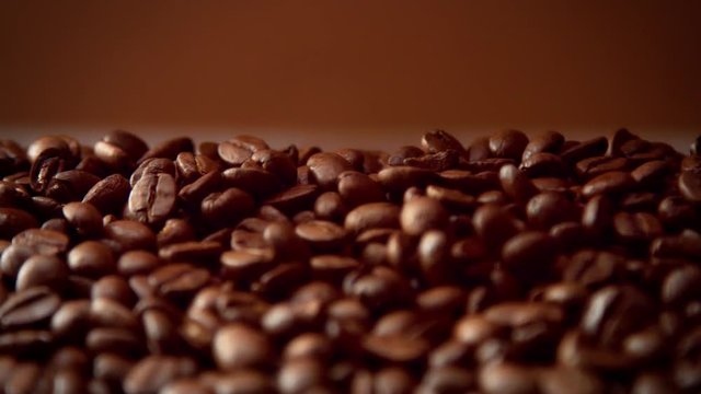 cofee beans closeup falling down slowmotion