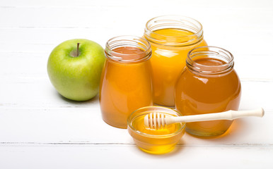 Honey in jar with honey dipper on wooden background