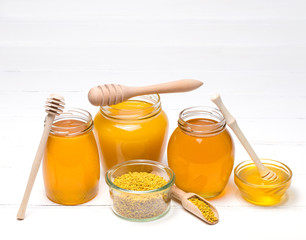 Honey in jar with honey dipper on wooden background