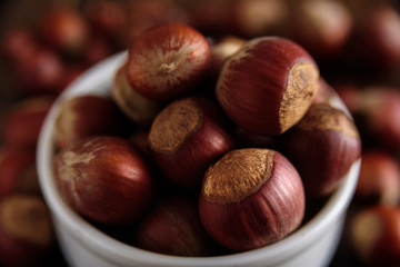 Hazelnuts in white ceramic bowl