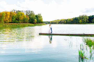 Fototapeta na wymiar beautiful lake with blue water and autumn trees along the coastl