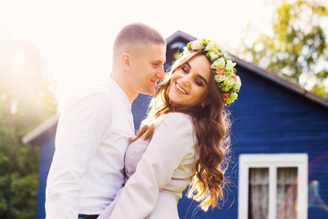 Fototapeta premium a loving man wants to kiss his wife with closed eyes against the