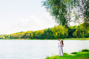 happy and smiling couple on the background of a beautiful lake a