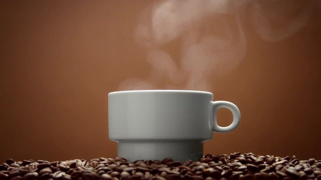 white cup on coffee beans with steam from hot drink. Perfectly loop