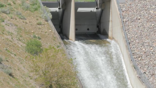 Water flowing out of flood gates during high water spring run off.