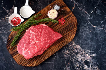 fresh meat with ingredients for cooking on stone background