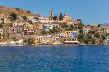 Fototapeta na wymiar View of the Bay and the colorful houses of Symi island, Greece