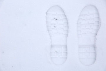 Footprints of shoes on fresh snow.