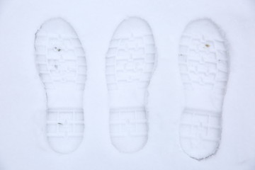 Footprints of shoes on fresh snow.