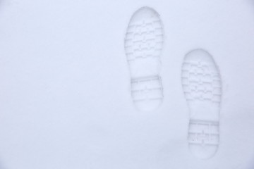 Footprints of shoes on fresh snow.