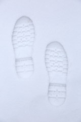 Footprints of shoes on fresh snow.