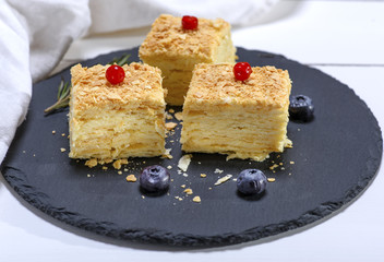 three slices of Napolon pie with cream