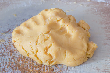 Raw dough for Polish babeczki cake on wooden desk.