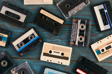 Cassette tape background, top view. Collection of a retro audio cassette on blue wooden background, close-up