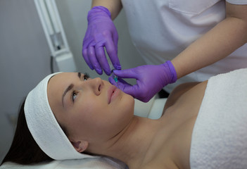 Obraz na płótnie Canvas Young woman getting cosmetic procedure.