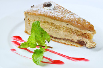 Peace of cake with strawberry topping and mint