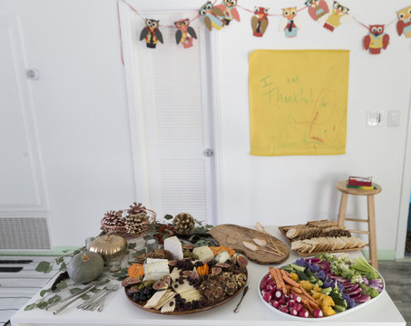 A Holiday Table Spread Of Appetizers And Kids Decorations