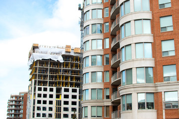 Construction and modern condo buildings with huge windows and balconies in Montreal, Canada.