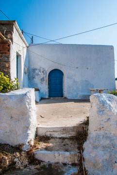 An old traditional house with a blue door in Antikythera island in Greece. An island between Kythera and   Crete