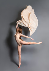 beautiful young girl dancing with cloth. Flying fluttering fabric.