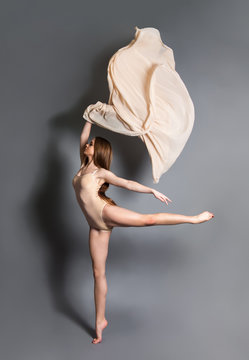 beautiful young girl dancing with cloth. Flying fluttering fabric.