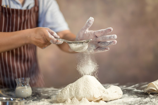 Chef Hipster Stylish Sifting Flour On Dough For Pastries In Kitchen