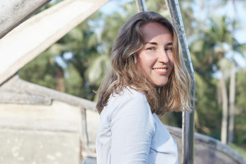 Fototapeta premium Feminine close up tender highly detailed capture of attractive woman dressed in natural cloth, wearing no make up, practicing healthy lifestyle. Caucasian lady posing outdoors gently looking at camera