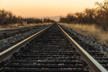 Obraz na płótnie Canvas Train tracks sunset converging lines