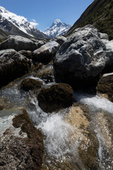 Mount Cook with river flowing over rocks in the foreground, Mount Cook Aoraki National Park, New Zealand