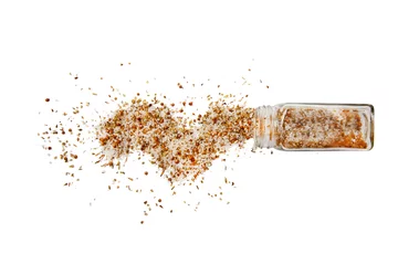 Foto auf Acrylglas moroccan seasoning. spilled moroccan seasoning mix. Isolated on a white background.  top view, flat lay © EvgeniiAnd