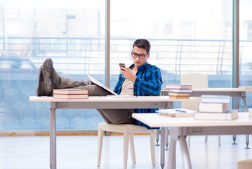 Student studying in the empty library with book preparing for ex