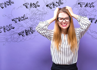 Tax with young business woman feeling stressed