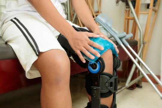 Patient Holding Cool Gel Pack On Knee For Pain Relief