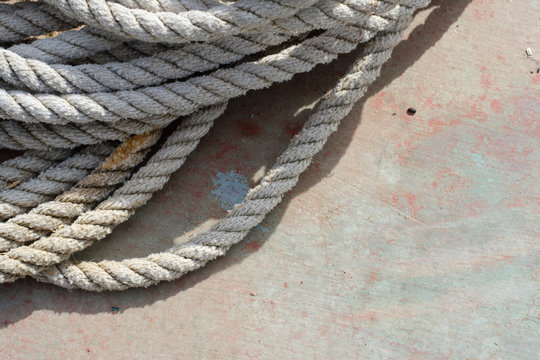 White hemp rope sitting on an old boat deck